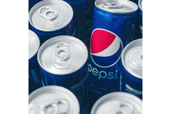 Image Pepsi cans in a group together.